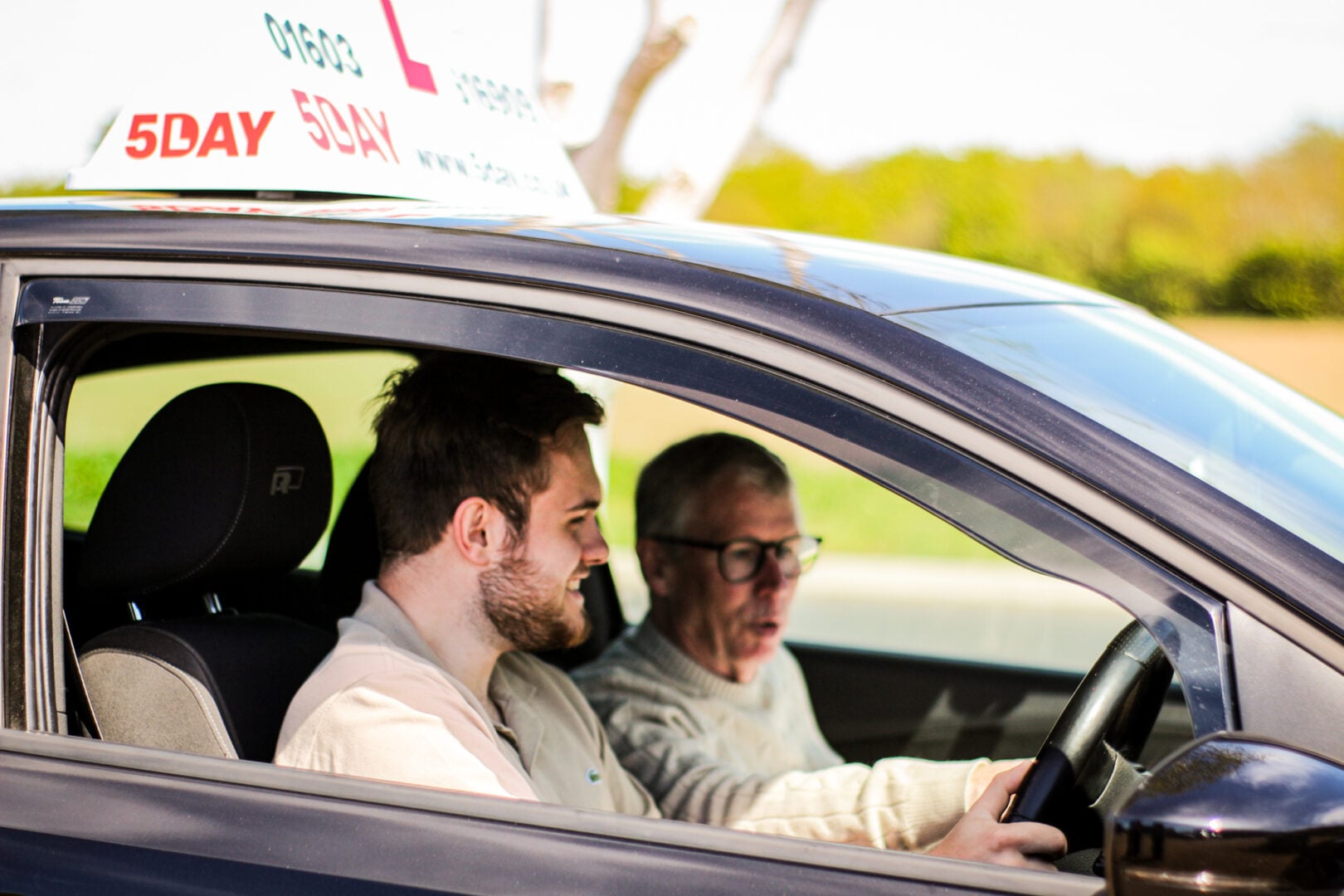 Driving instructor with learner in 5day branded car