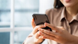 Woman looking at her phone in her hands