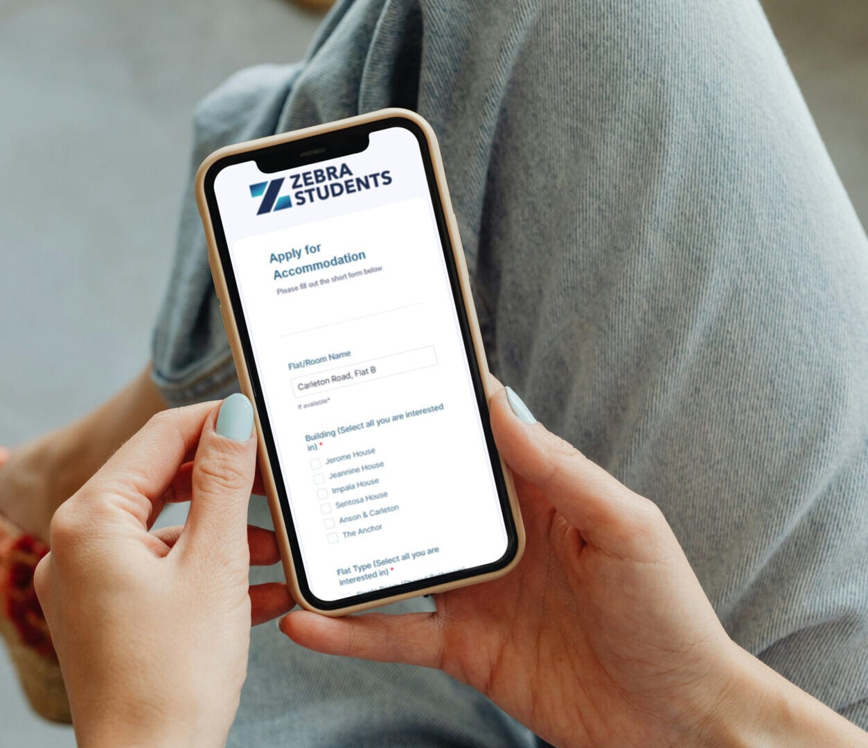 Up close of hands holding a phone with jotform application on the screen