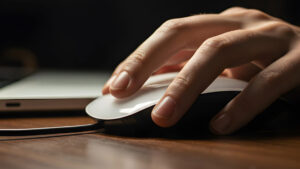Up close image of a hand using a computer mouse